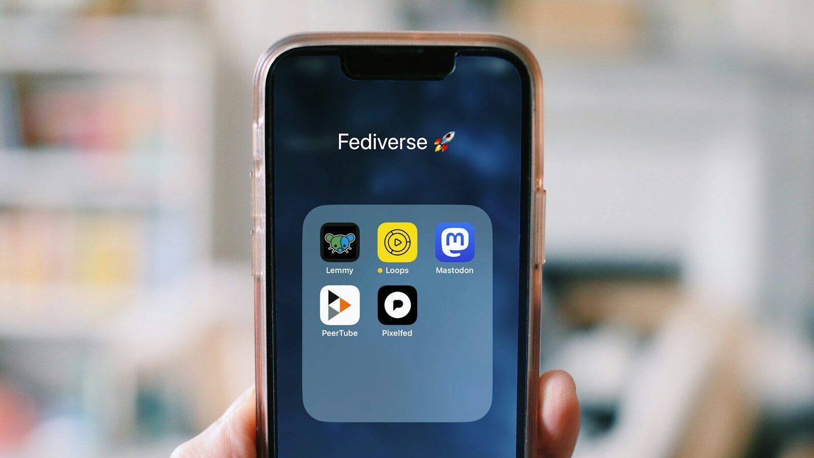 A person holding a smart phone in their hand
