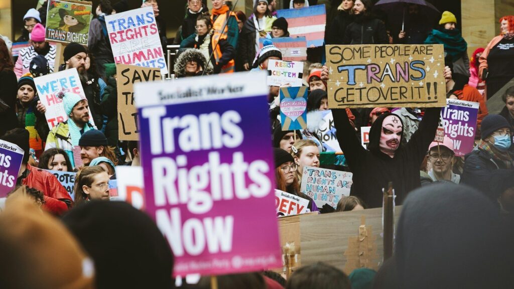 a crowd of people holding signs in the air