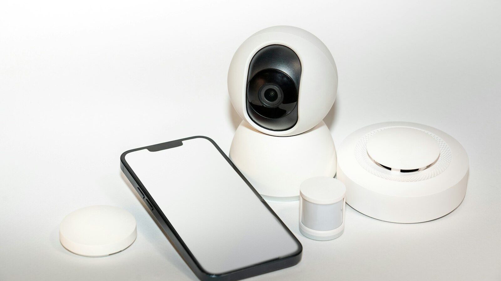a smart phone sitting next to a security camera