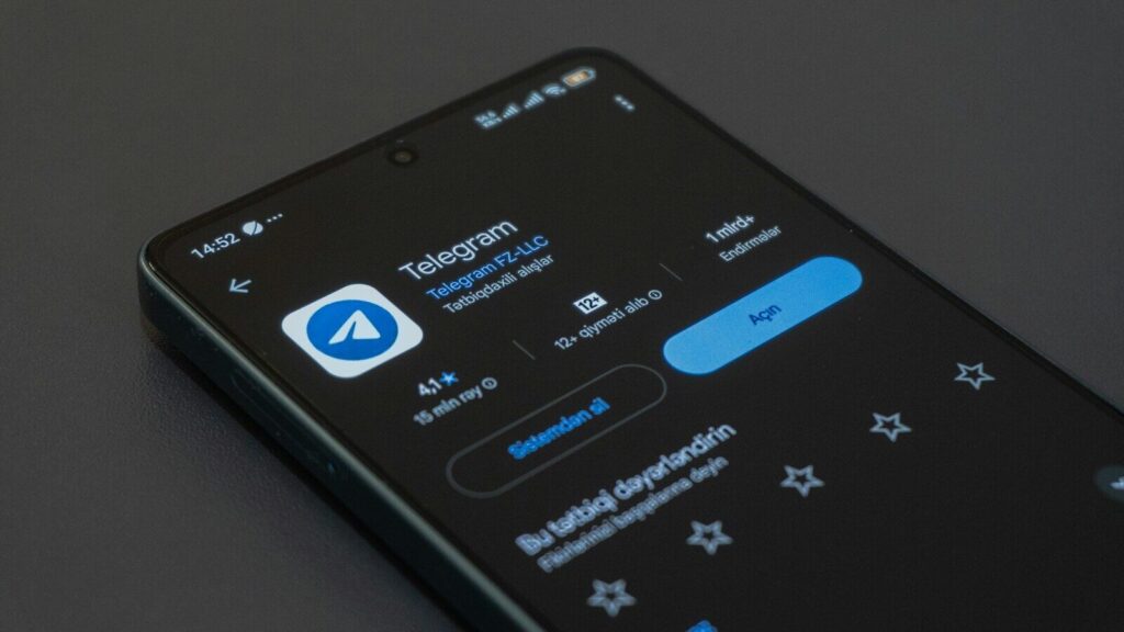 A phone screen displays the telegram app.