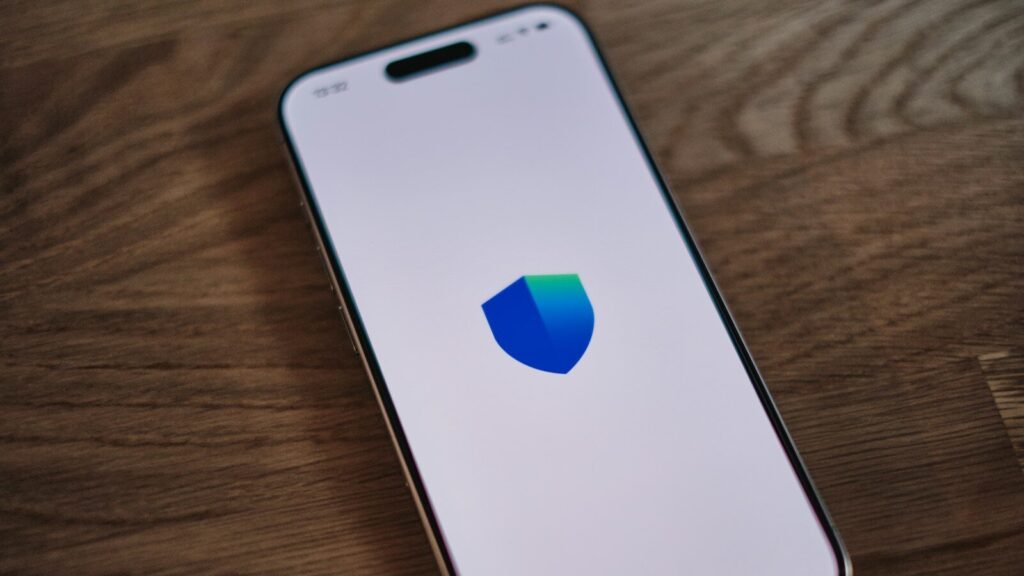 A cell phone with a shield logo on it