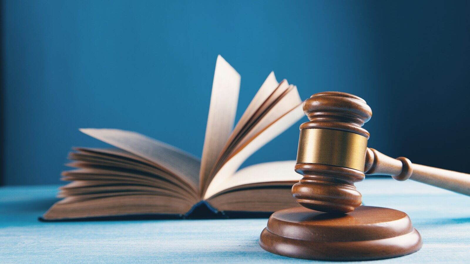 judges gavel and open book on table