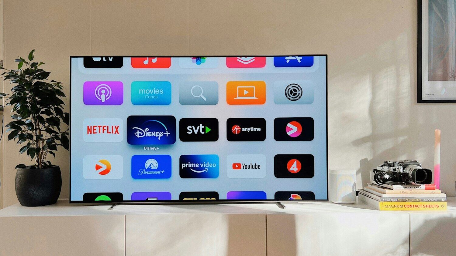a flat screen tv sitting on top of a white cabinet